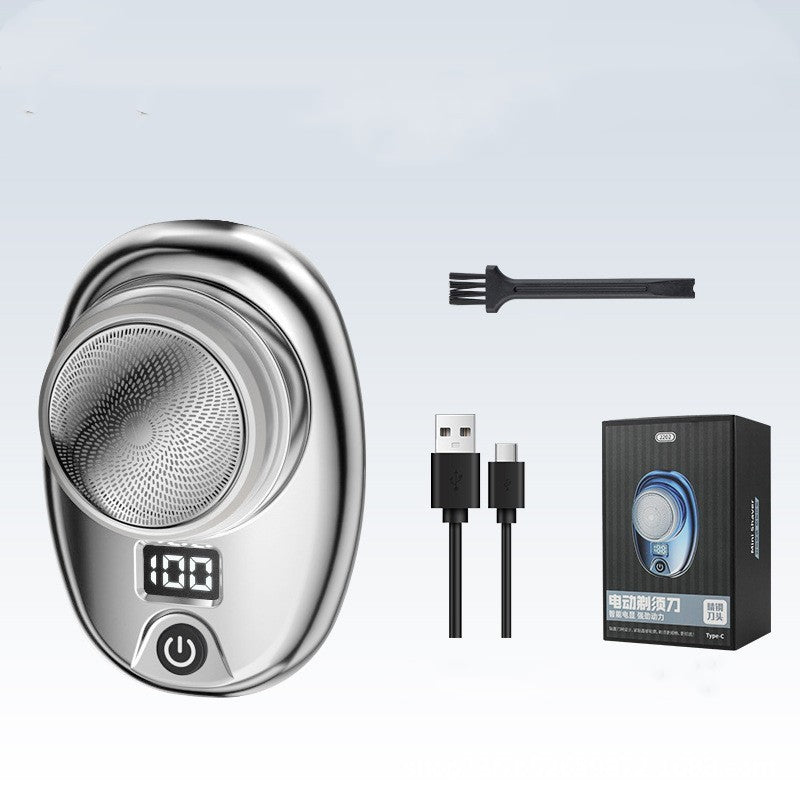 Electric shaver set with shaver, brush, USB cable, and packaging on a light gray background