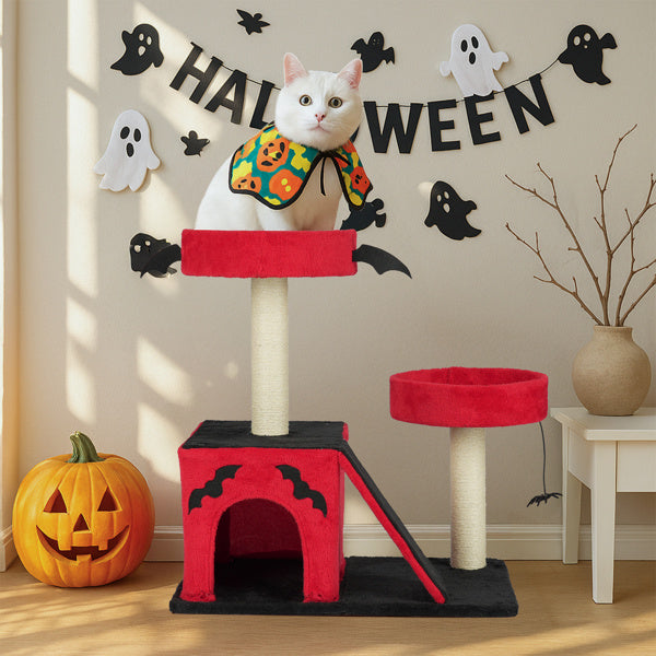 Cat on a Halloween-themed cat tree with decorations and a pumpkin.