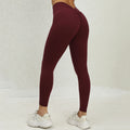 Maroon leggings worn by a person on a light background