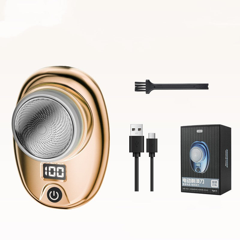 Gold electric shaver with brush, USB cable, and packaging on a white background