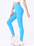 Person wearing bright blue leggings and white sneakers on a white background