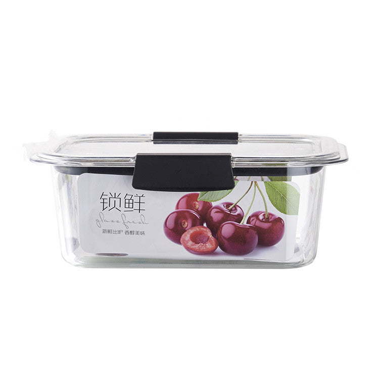 Clear glass food container with black handles and cherry design on a white background
