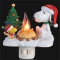 Decorative night light featuring Snoopy and Woodstock by a campfire with a Christmas tree in the background.