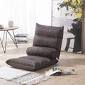 Brown floor pillow on a wooden floor with a table and books in the background; Compact folding floor recliner in assorted colors