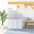 Stack of white storage drawers in a room with a plant and bench