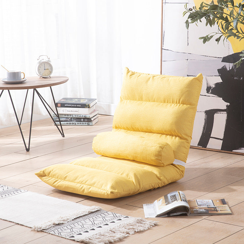 Brown floor pillow on a wooden floor with a table and books in the background; Foldable single lazy sofa recliner chair