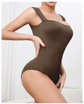 Brown romper jumpsuit worn by a model on a white background