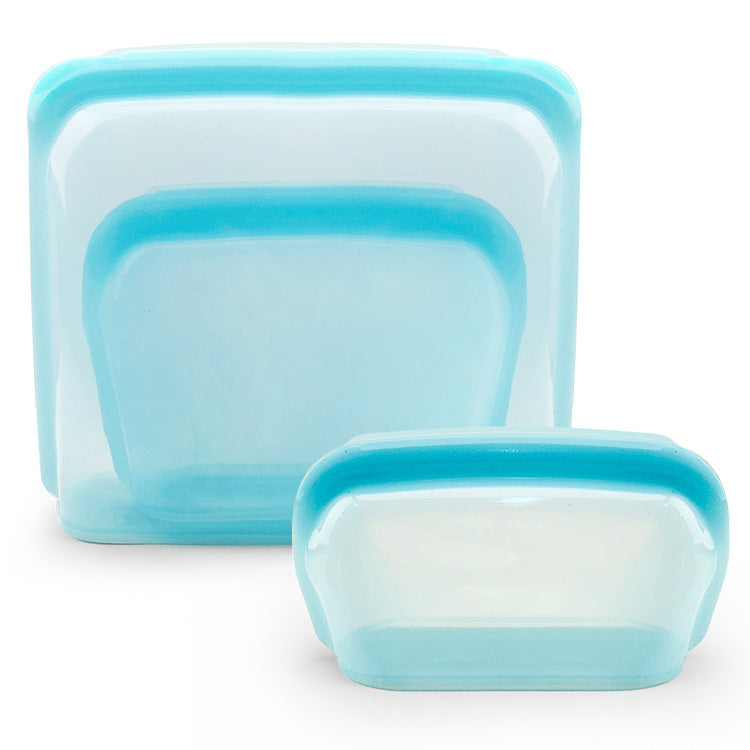 Set of three blue silicone food storage containers on a white background