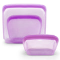 Set of three purple silicone food storage containers on a white background