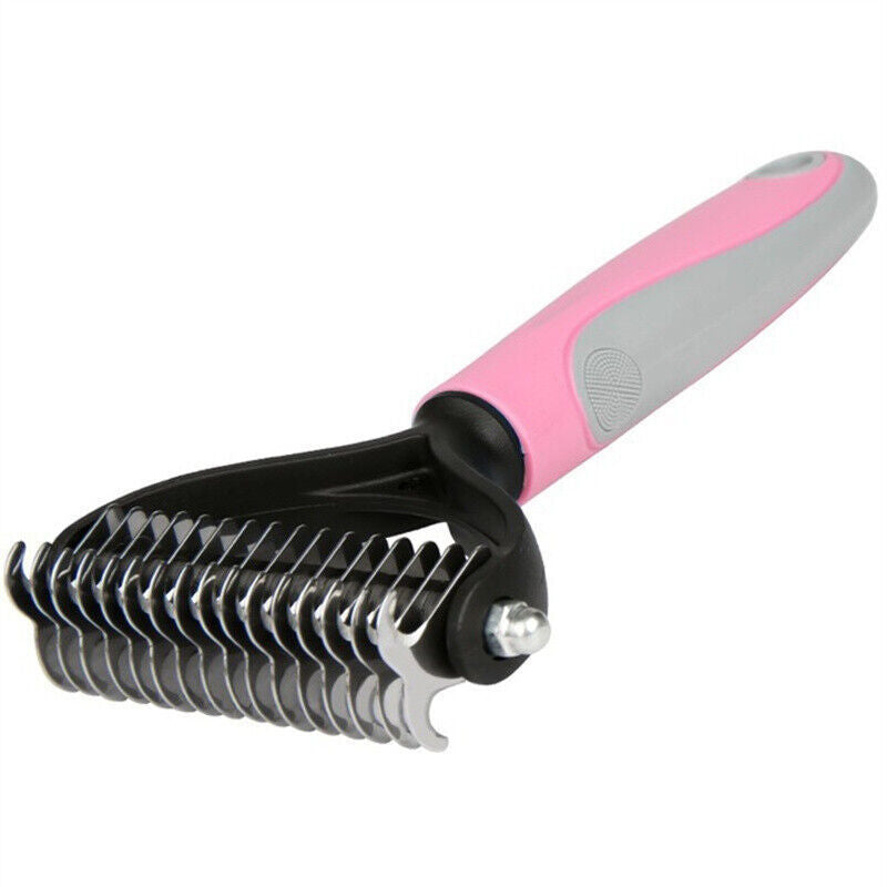 Pet grooming brush with pink handle on a white background