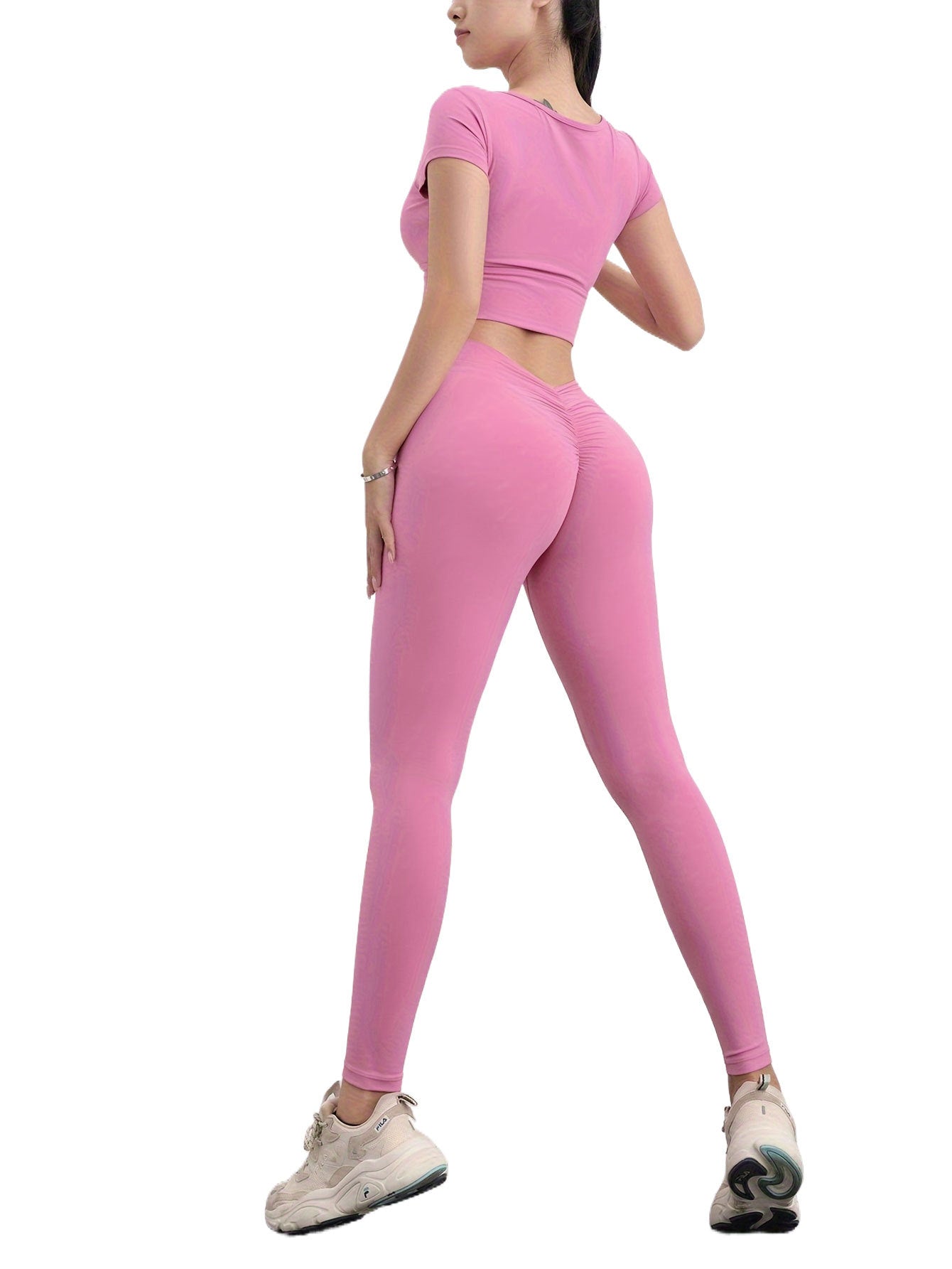 Person wearing a pink athletic outfit on a white background