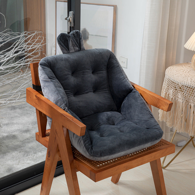 Wooden chair with dark gray cushion in a room setting; featuring ergonomic design with tufted cotton filling