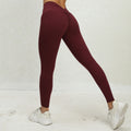 Maroon leggings worn by a person on a light gray background