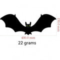 Black bat-shaped object with measurements on a white background
