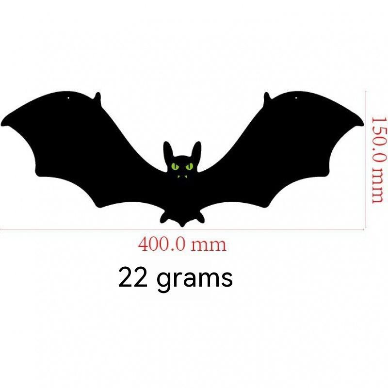 Black bat-shaped object with measurements on a white background