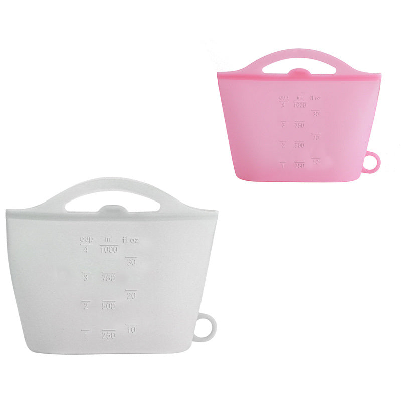 Two silicone measuring cups, one pink and one white, on a white background