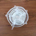 Set of clear silicone stretch lids on a wooden surface