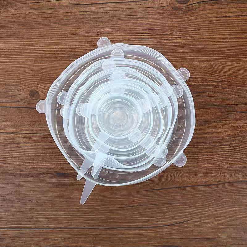 Set of clear silicone stretch lids on a wooden surface