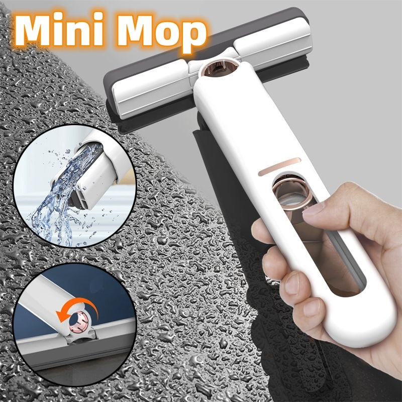 Mini mop with water being applied to a surface, held by a hand.