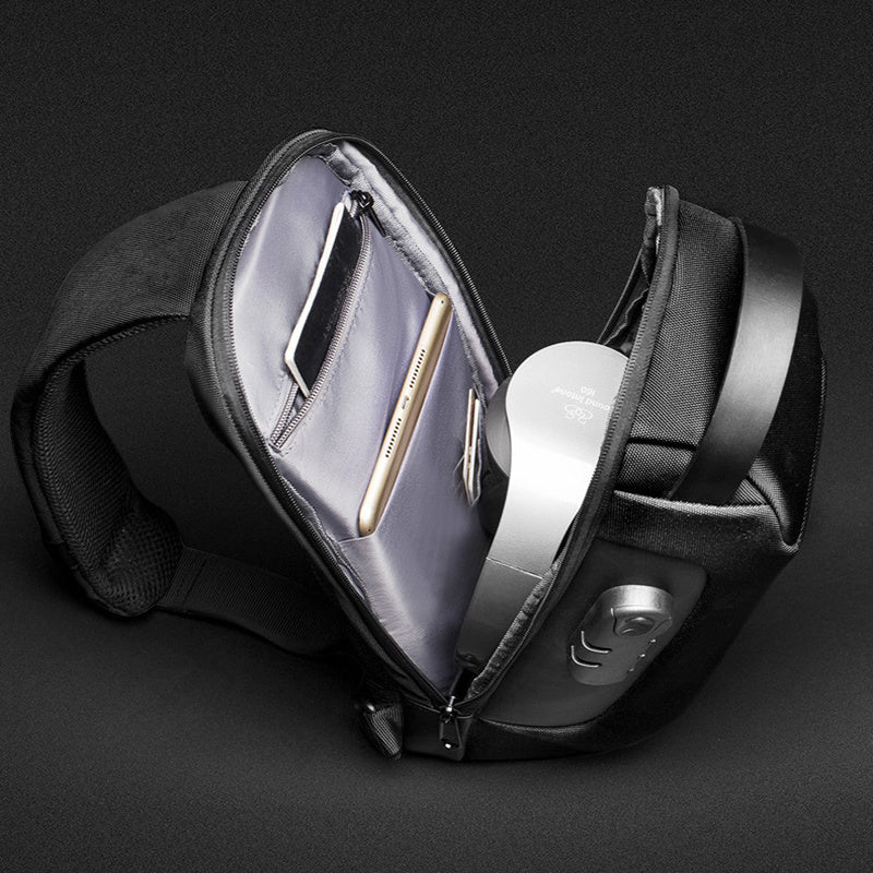 Black waist bag with open compartment on a dark background