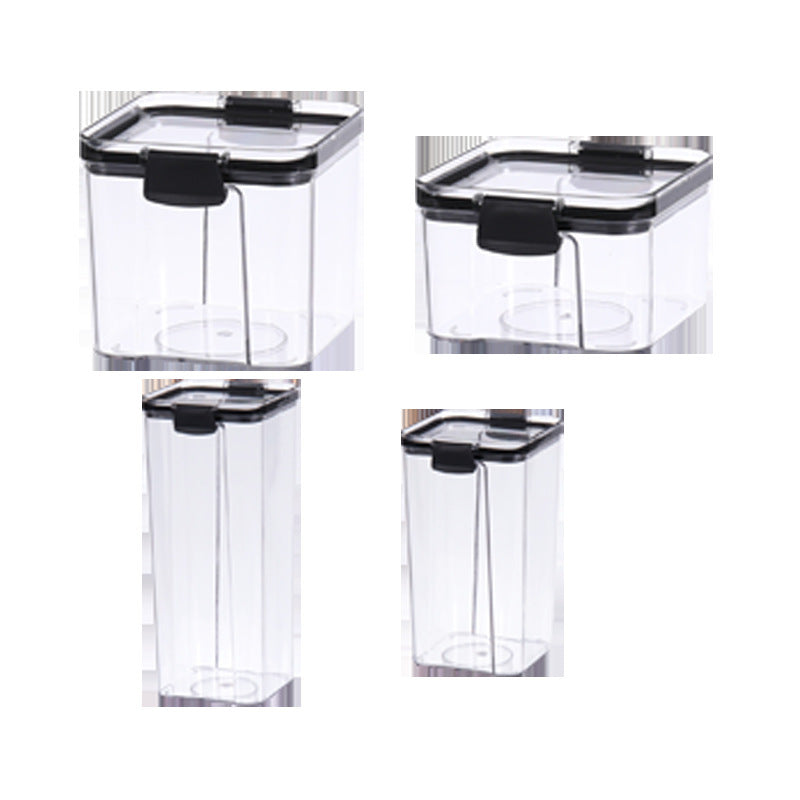 Set of clear food storage containers with black lids on a wooden surface