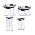 Four clear storage containers with black lids on a white background