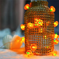 LED pumpkin string lights glowing in warm white for Halloween décor