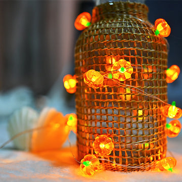 LED pumpkin string lights glowing in warm white for Halloween décor