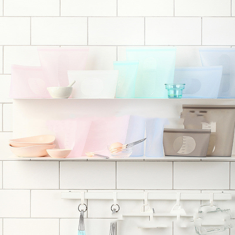 Shelves with decorative items against a white tiled wall; BPA-free vacuum food storage pouch
