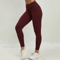 Maroon leggings worn by a person on a white background