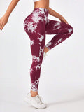 Maroon and white tie-dye leggings worn by a person on a white background