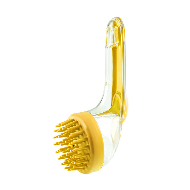 Yellow grooming brush with clear handle on a white background