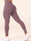 Purple leggings worn by a person on a white background