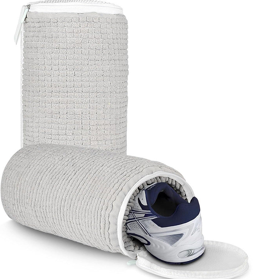 Gray textured shoe bag with a white sneaker inside on a white background